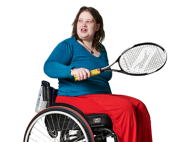Woman in a wheelchair, with a tennis racket in her hand, looking over her shoulder