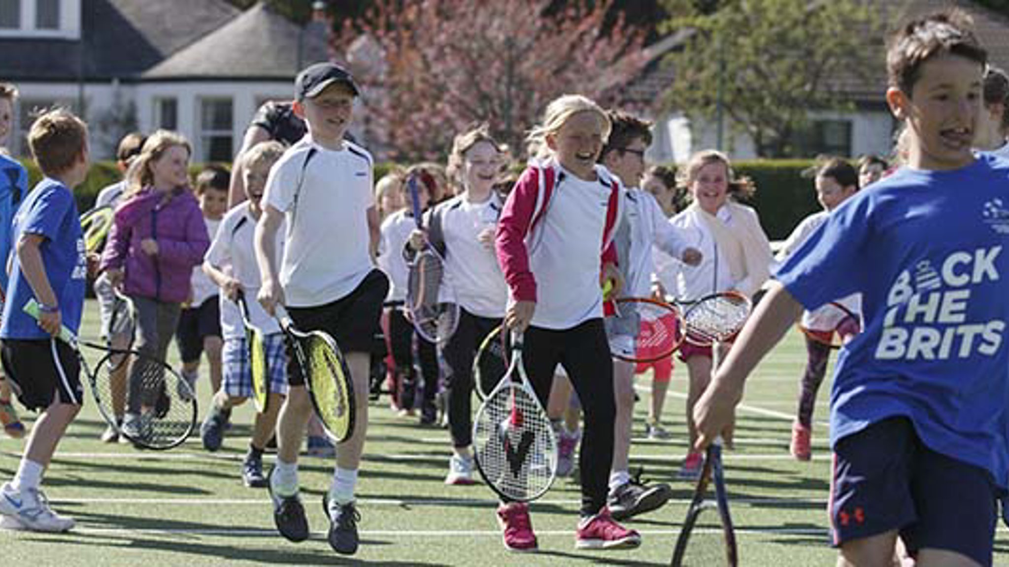 Children running with tennis rackets at Clarkston Tennis Club