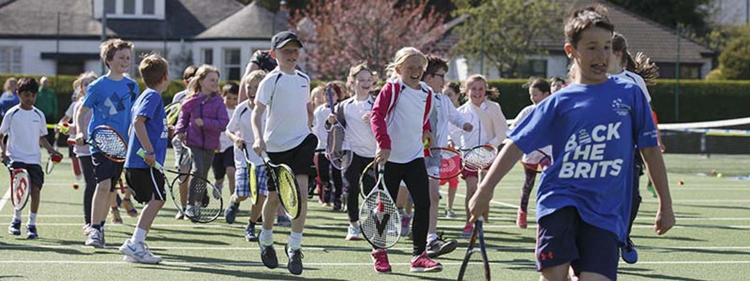 Children running with tennis rackets at Clarkston Tennis Club