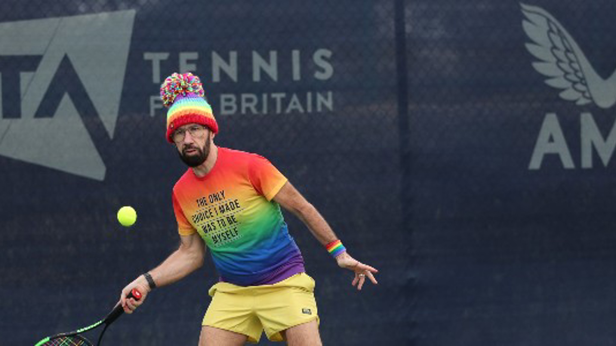 A male tennis player on court at the Pride in Tennis event at the National Tennis Centre