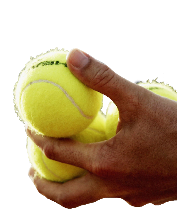 Cut out of tennis balls being held by a person