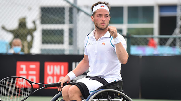 Tennis player on a wheelchair holding a racket
