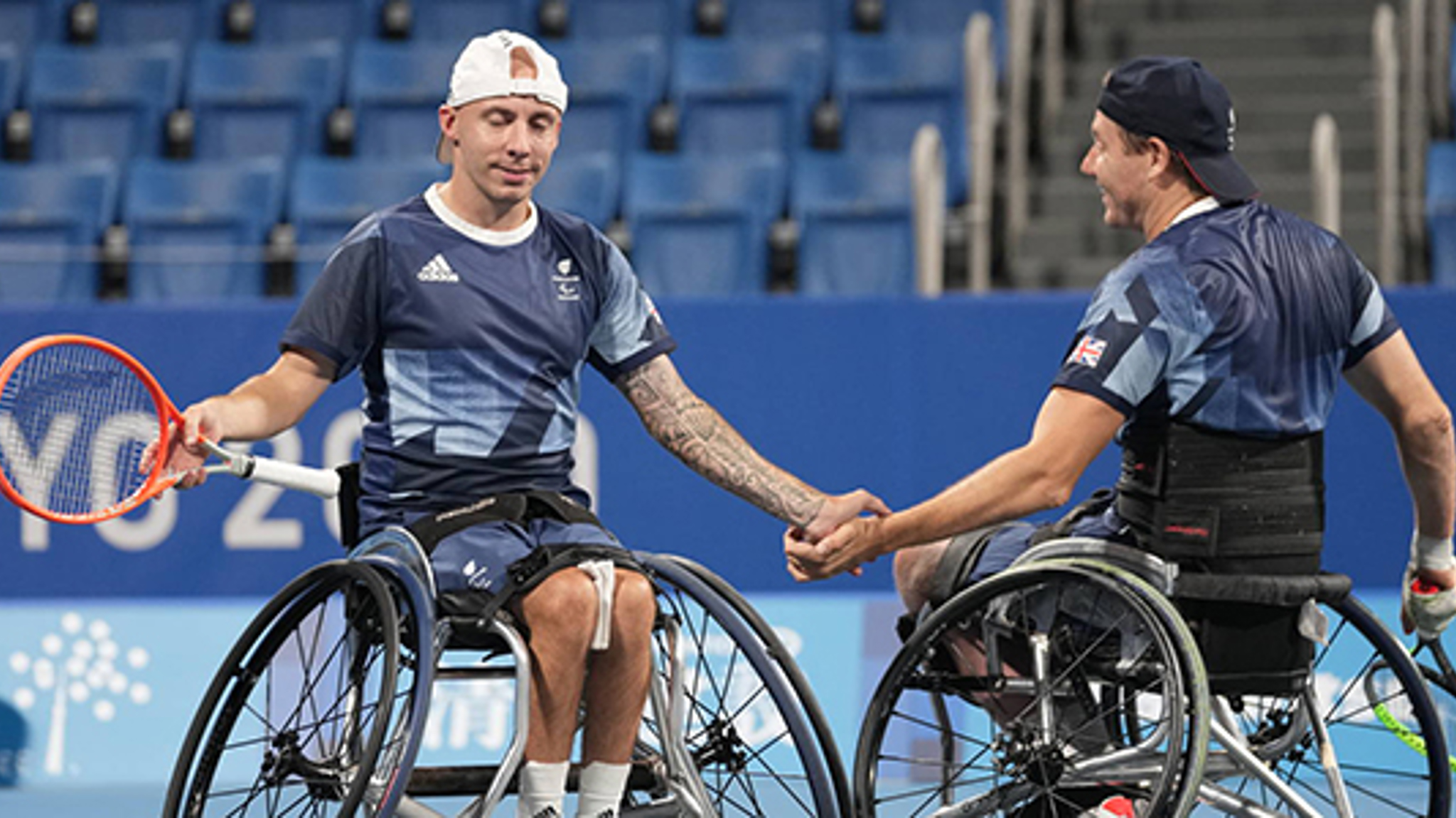 Two paralympic players shaking hands 