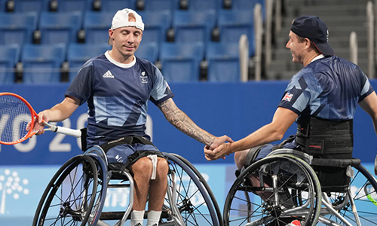 Two paralympic players shaking hands 