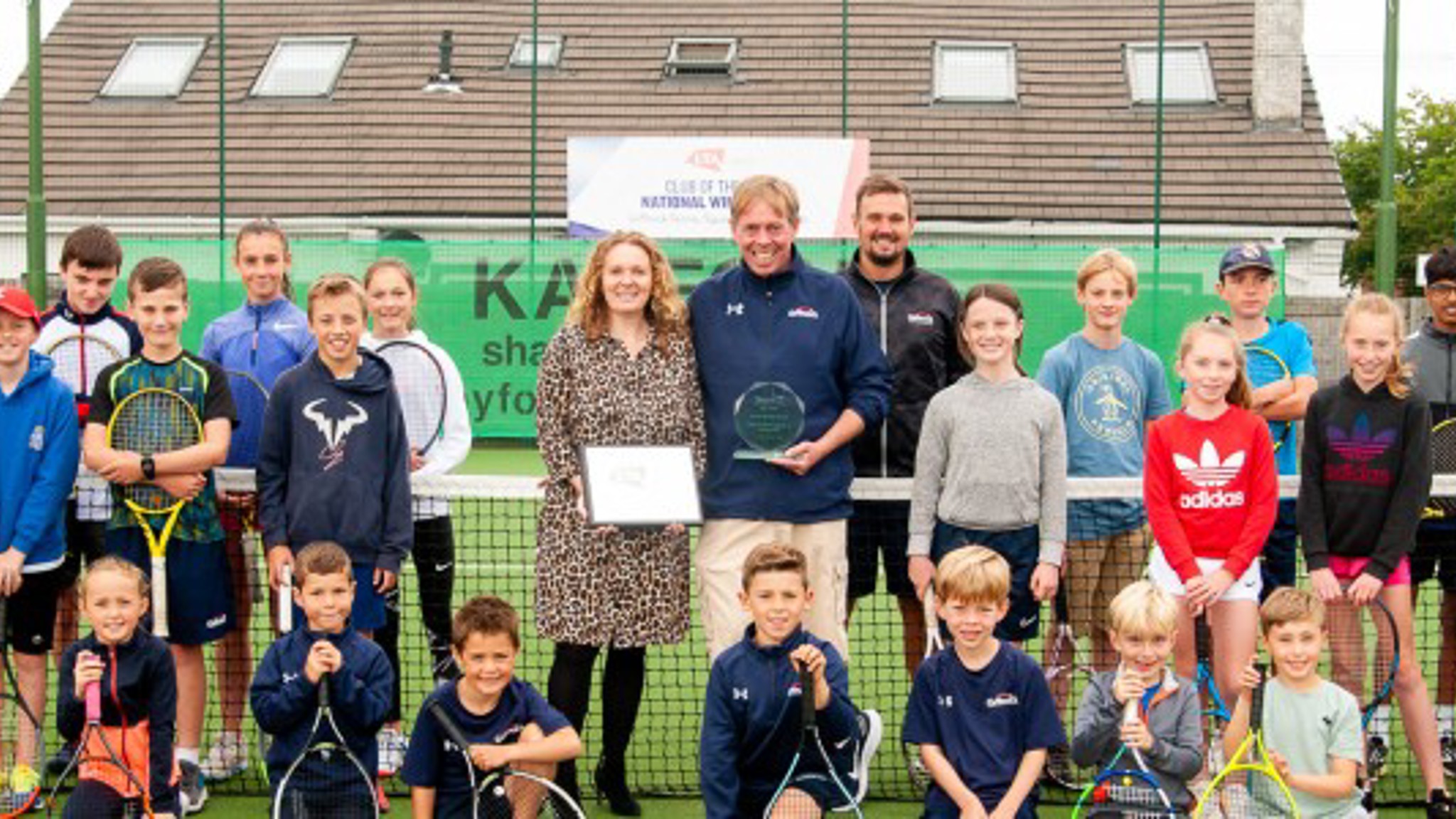 Gourp of kids holding rackets
