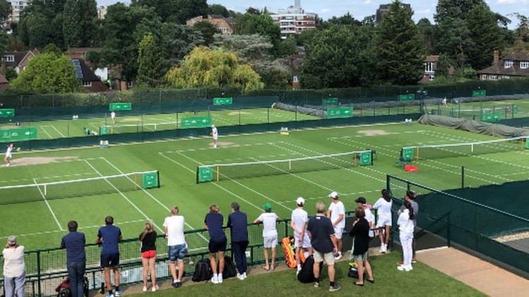 A group of people watching tennis matches