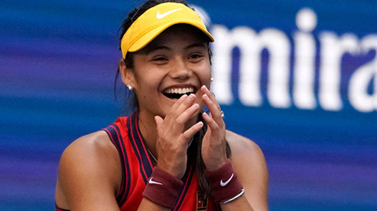 Emma Raducanu smiling for a picture as she wins