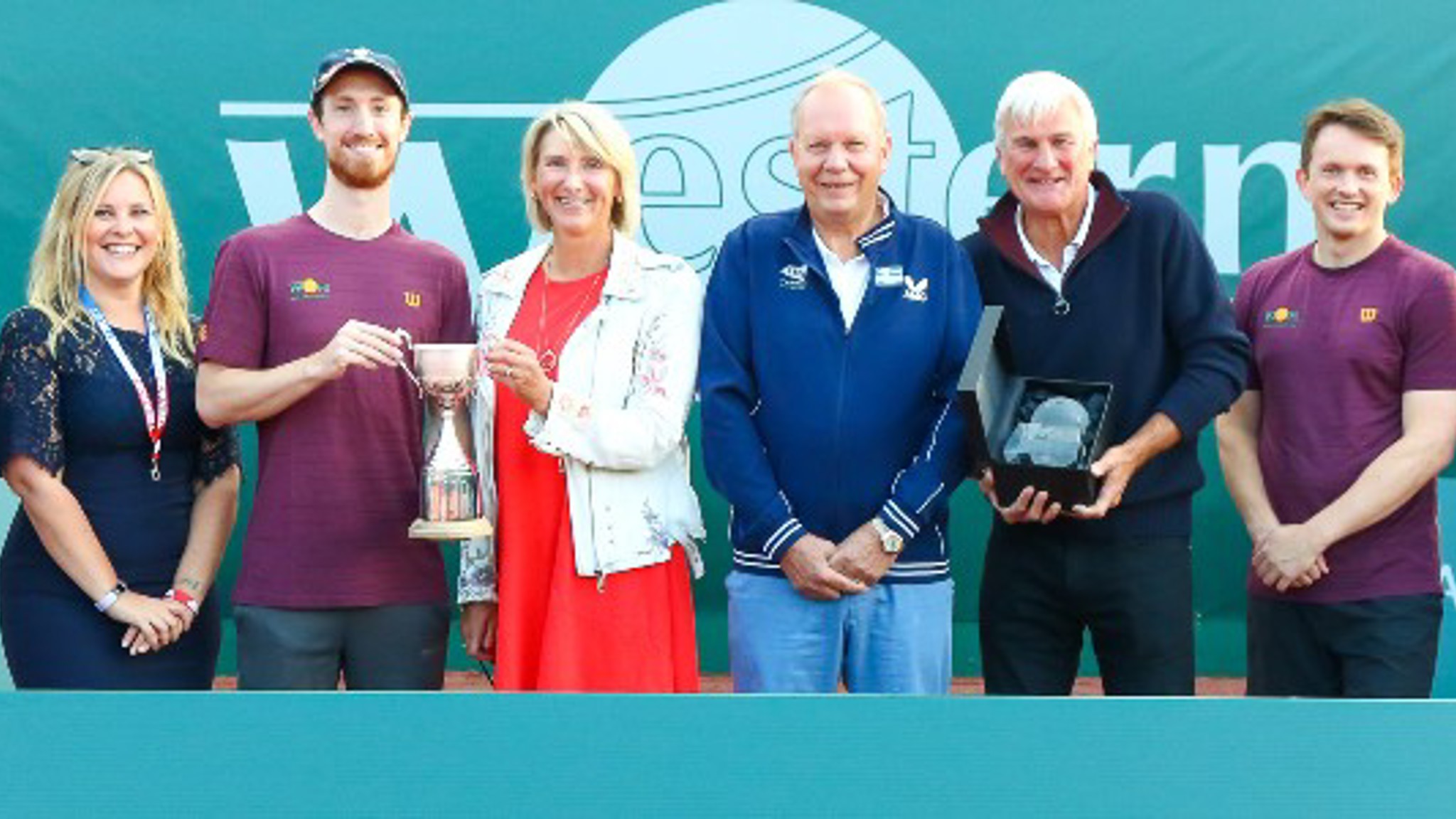 A group of people presenting their trophie