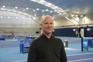 LTA colleague Michael Salmon standing in front of the indoor hard courts at the National Tennis Centre