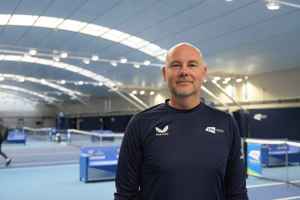LTA colleague Steven Fathers standing in front of the indoor hard courts at the National Tennis Centre