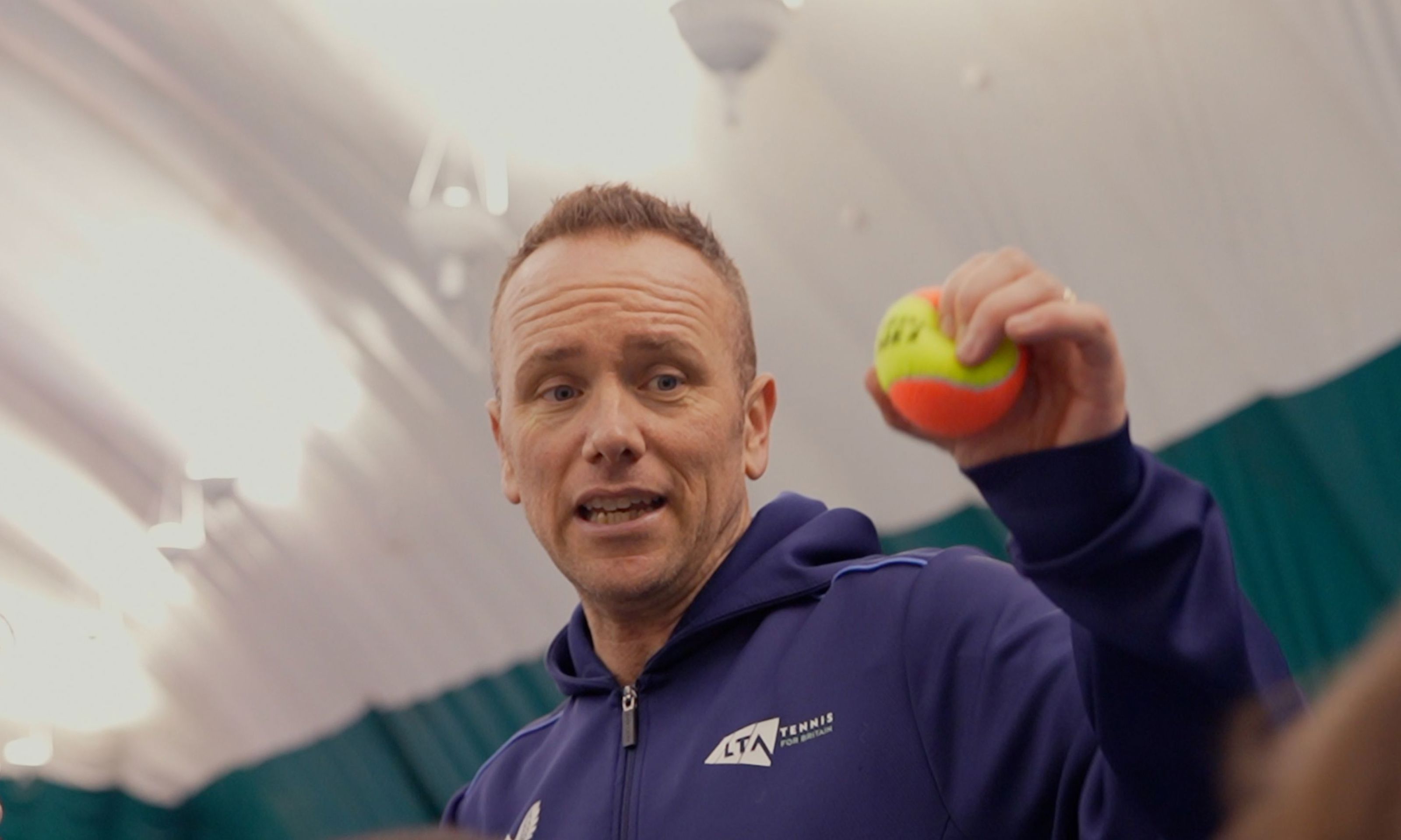 Coach, Mark Hayden holding up a ball during a session