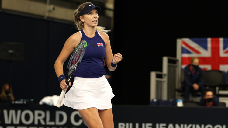 Katie Boulter celebrating on a tennis court with her tennis racket in front of an audience