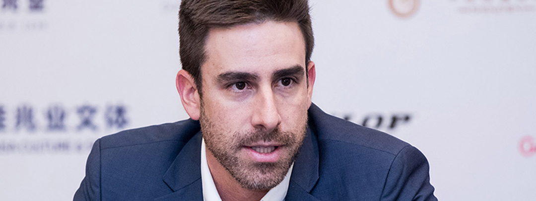 A close up of Luiz Procopio Carvalho in a suit