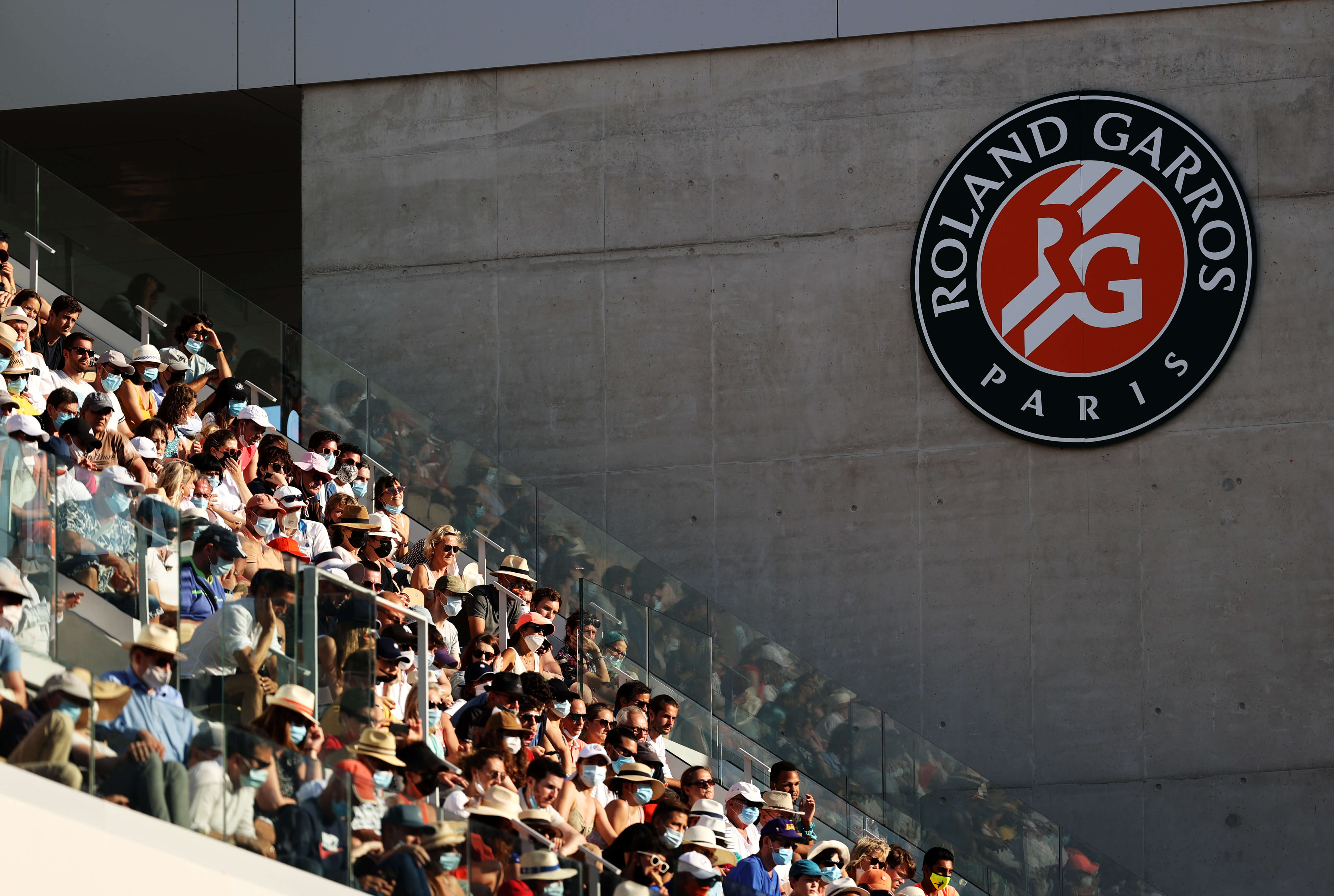 A general view of the stands as spectators wearing masks watch on during the Men's Doubles Final on day fourteen of the 2021 French Open at Roland Garros