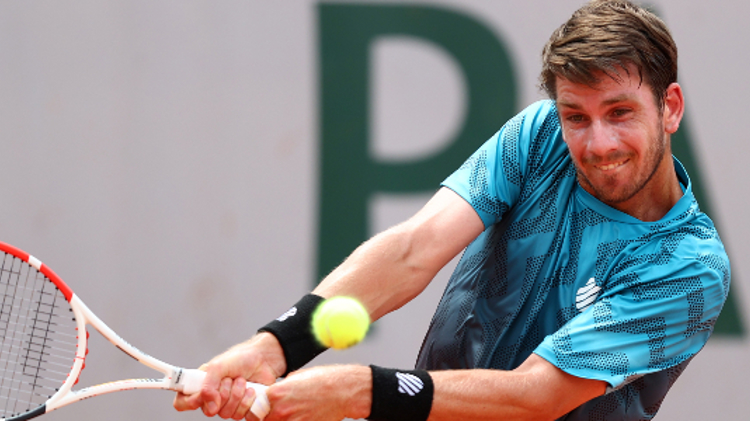 Cam Norrie playing a double forehand shot in a tennis match
