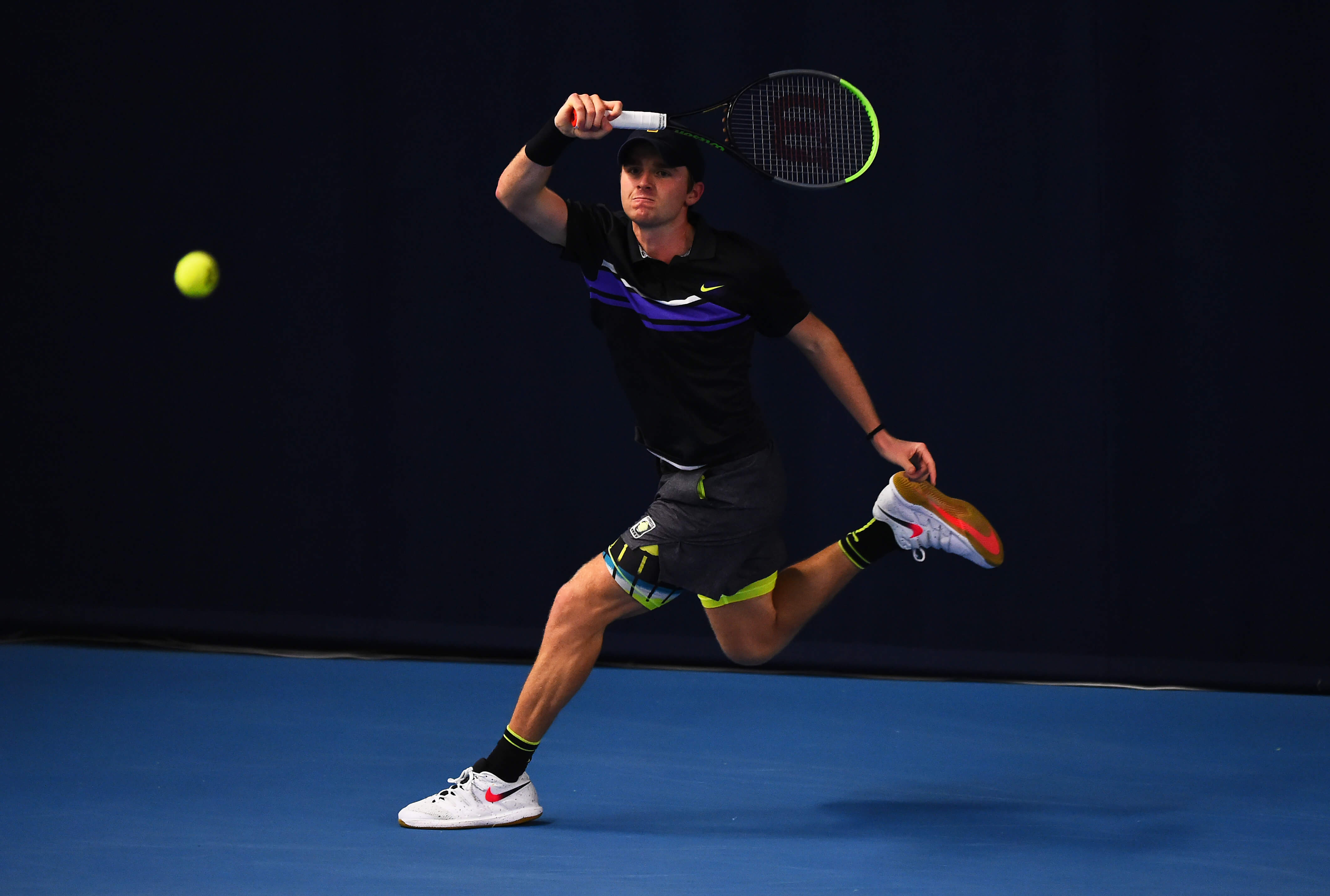 idan McHugh plays a forehand shot during their round robin match against Jack Pinnington Jones during Day Four of the Battle of the Brits Premier League of Tennis at the National Tennis Centre on Decemb