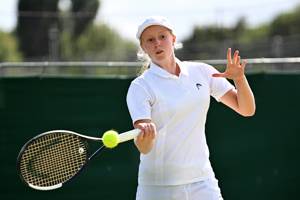 Daniella Britton strikes a forehand while competing in a match at the lexus British Open Roehampton
