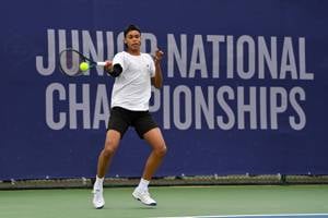 Issac Sallu strikes a forehand at the Lexus Junior National Championships