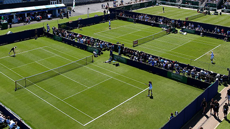 birds eye view of three of wimbledons grasscourts with singles matches being played on all courts