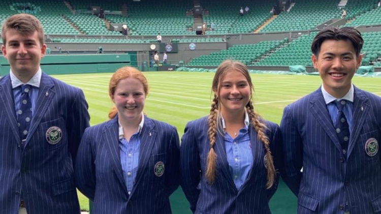 four new officials for the 134th championship standing in front of a Wimbledon tennis court