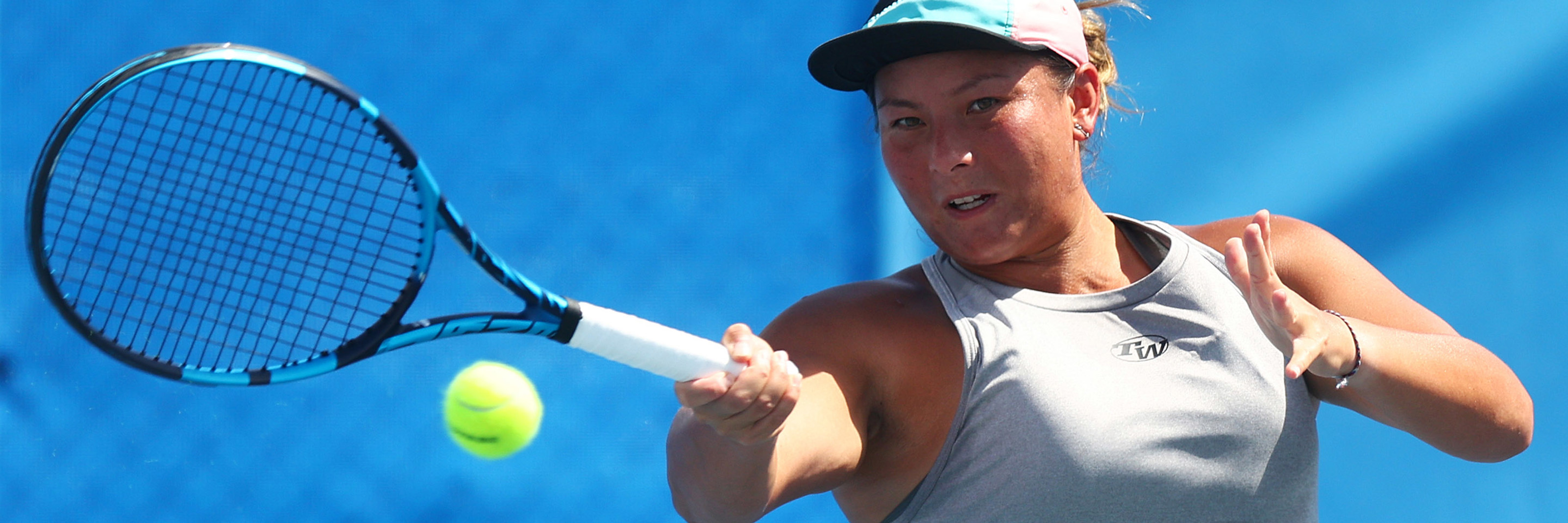 Tara Moore hitting a forehand in a match in 2021