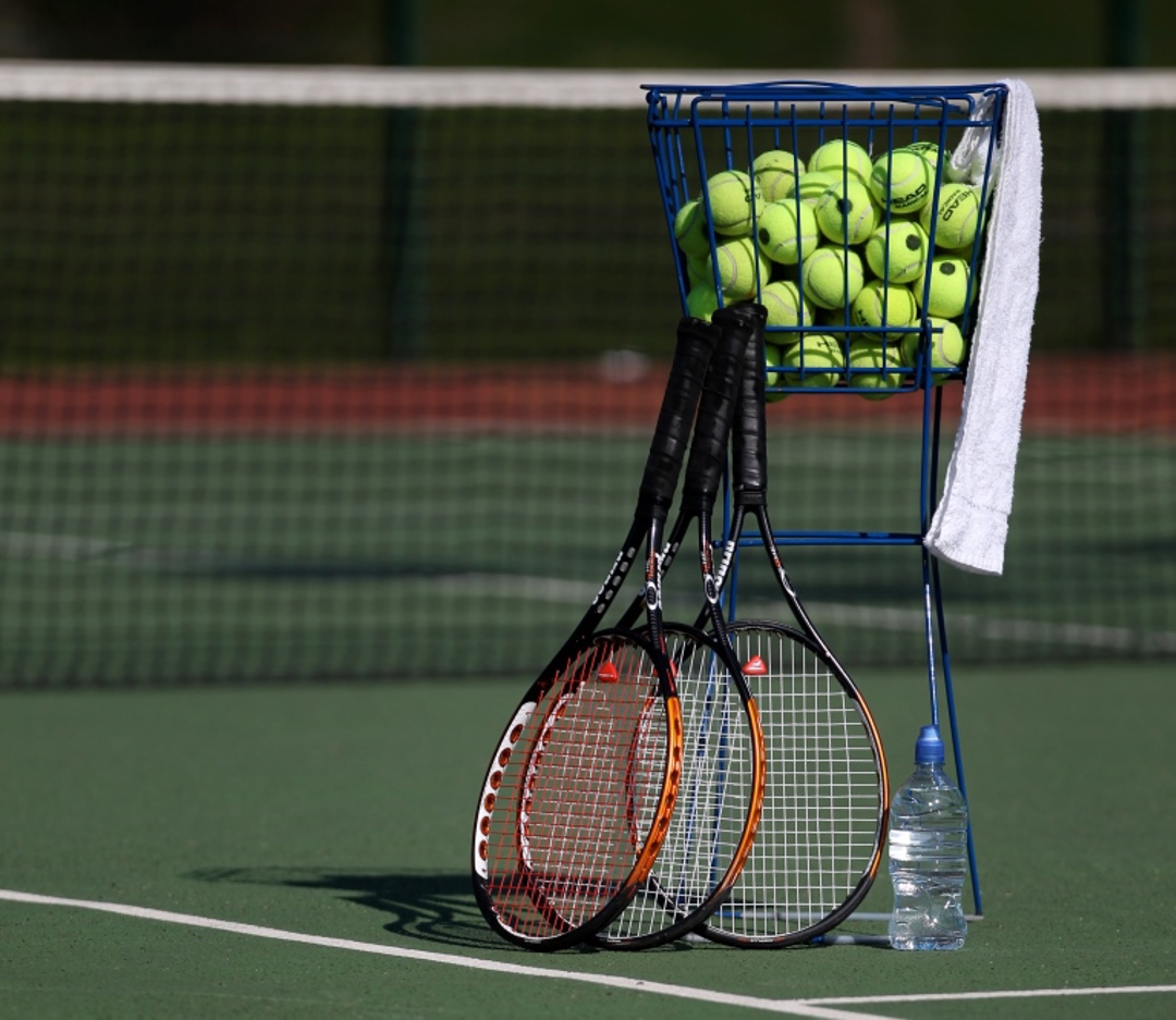 Tennis rackets with tennis balls on a court