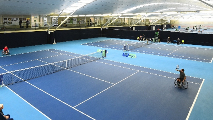 A wheelchair match taking place inside at the National Tennis Centre