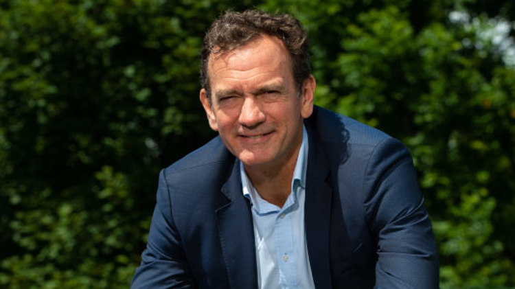 image of chief executive blane dodds smiling in a  suit