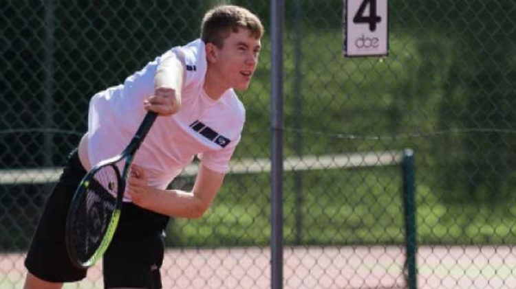 ben hudson serving in a match at the four nation junior championships