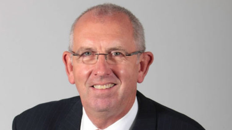 headshot image of chairman graham watson in a suit smiling