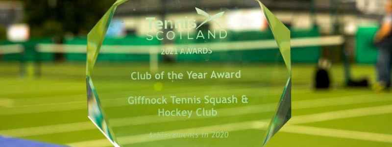clear glass LTA award trophy with writing  saying club of the year award for giffnock tennis squash and hockey club
