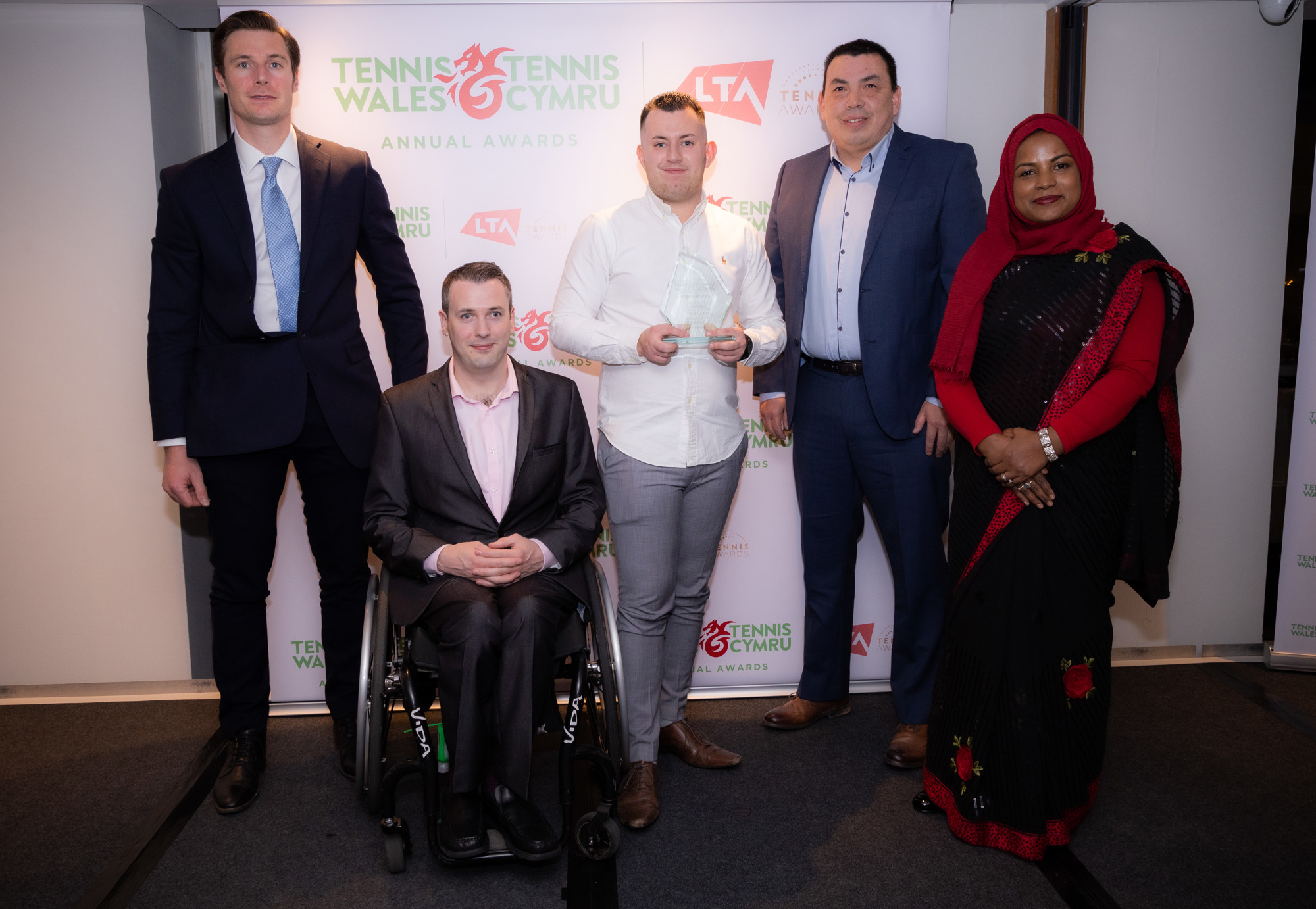 5 people standing at the tennis disability award show
