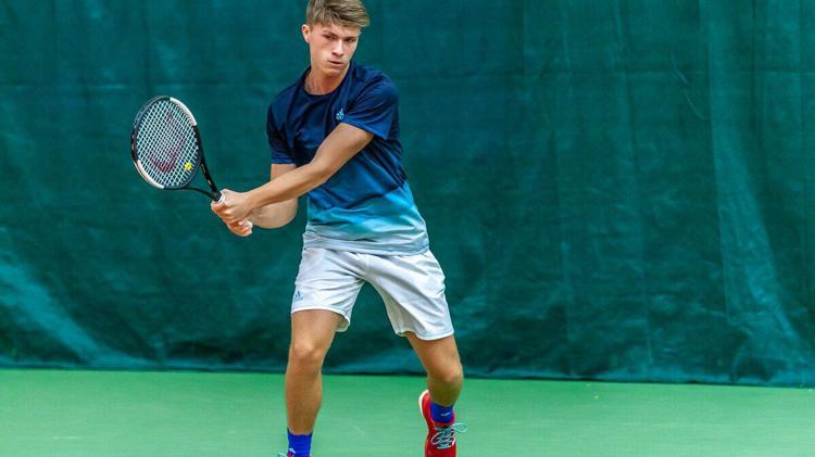 James returning a shot mid tennis game