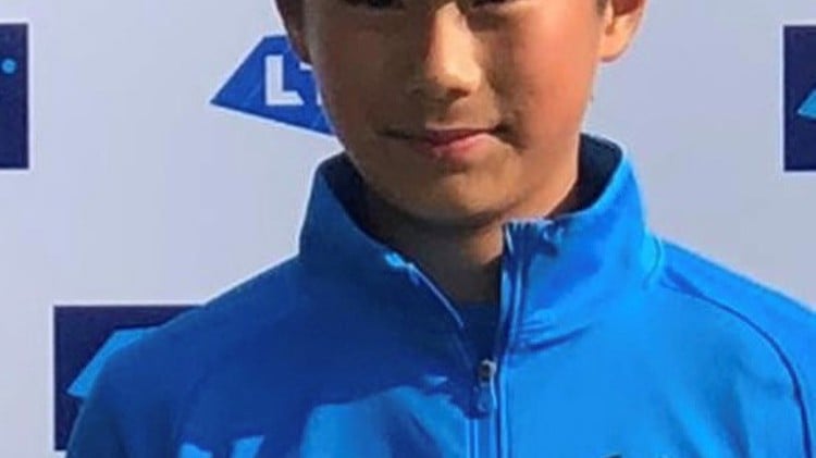 Rundong posing with a tennis trophy