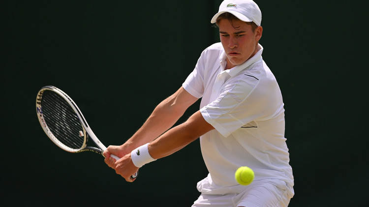 Male tennis player returning a shot in a rally 