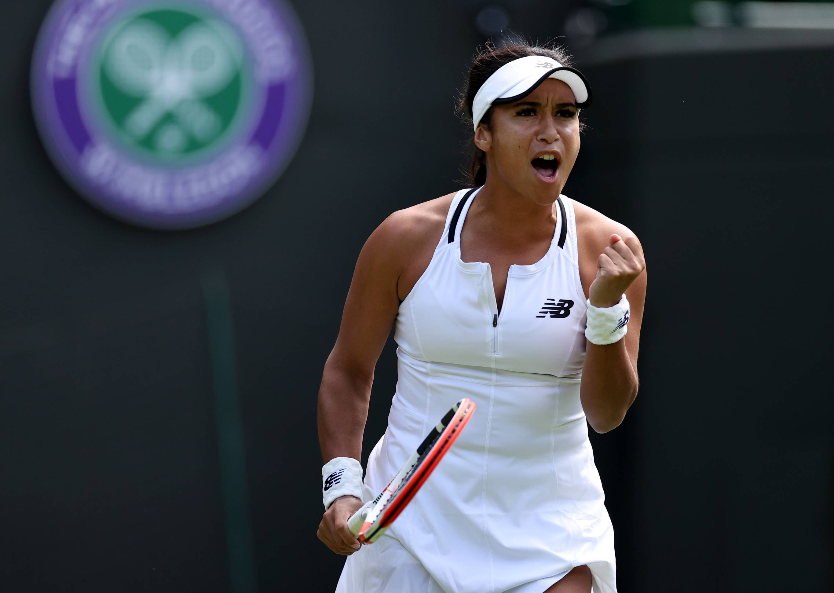 Heather Watson clenching her fist while shouting on court at Wimbledon