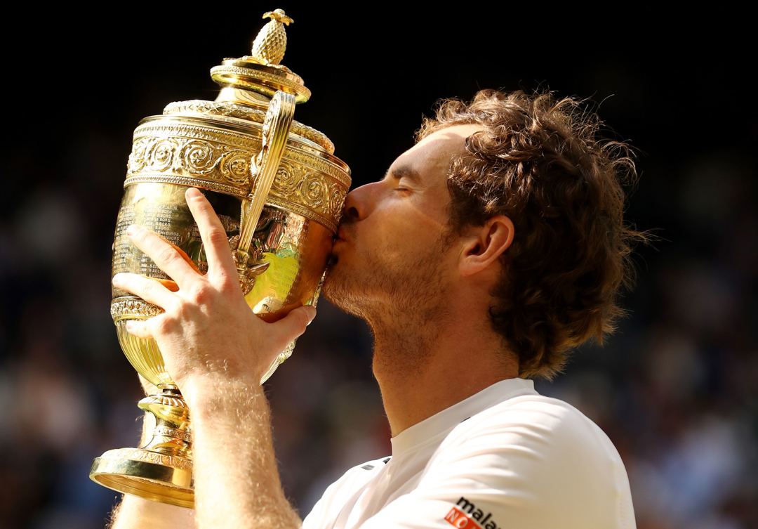 Andy Murray kisses the trophy after being crowned Wimbledon champion for the second time in his career