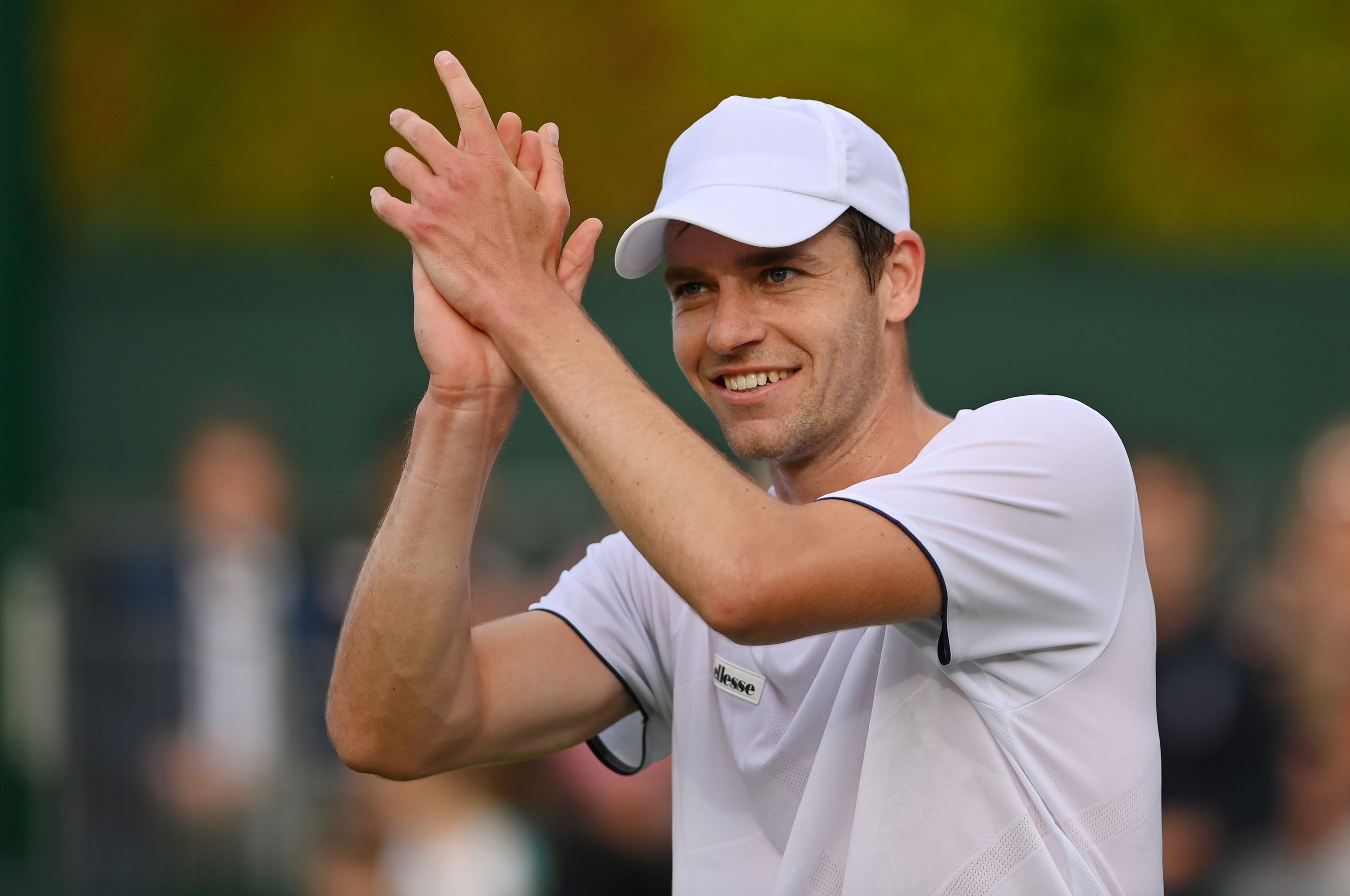 Alastair Gray applauds the crowd after winning on his Wimbledon debut