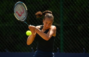 Female tennis player returning a serve