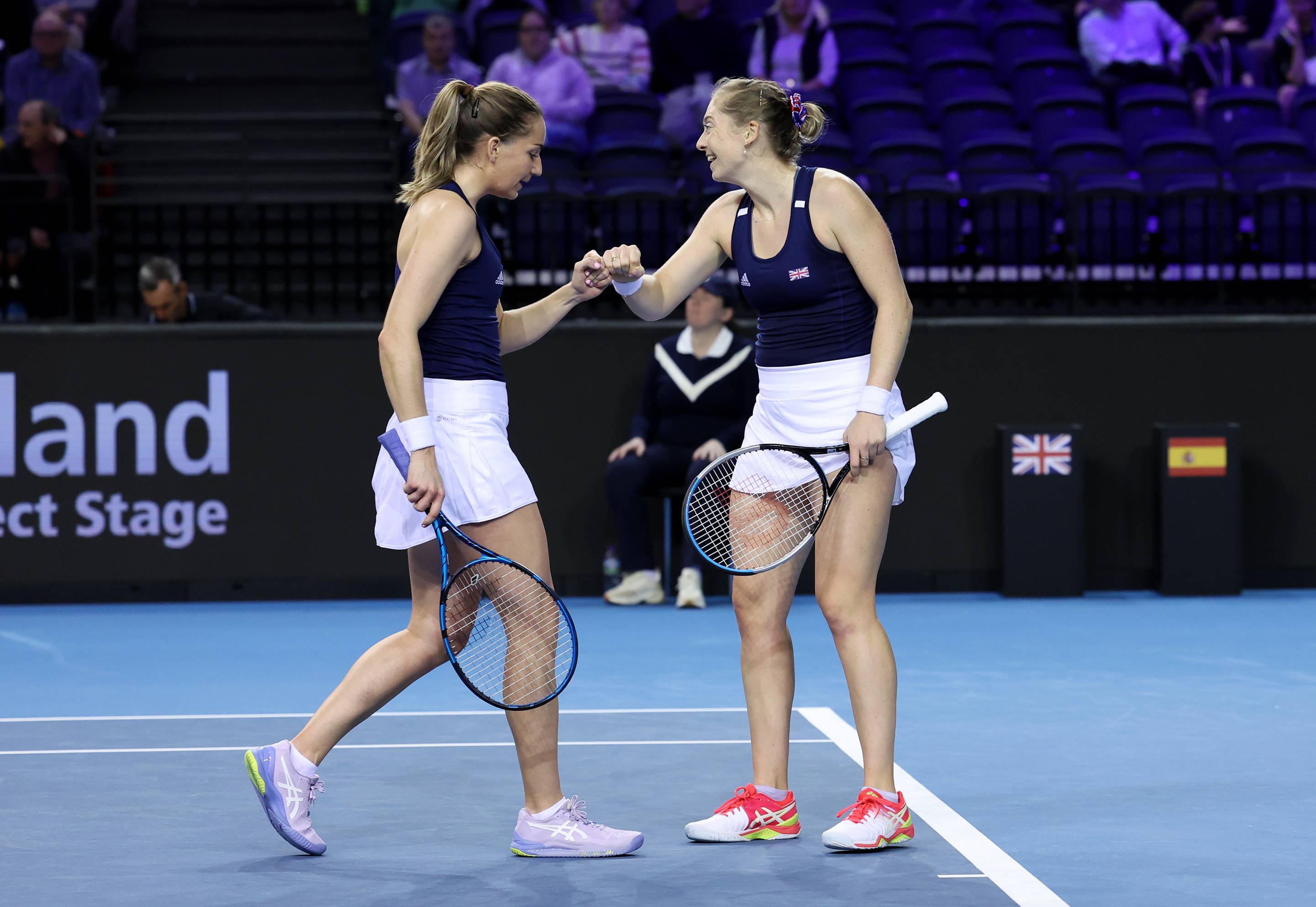 Olivia Nicholls and Alicia Barnett fist bump against Spain at the Billie Jean King Cup
