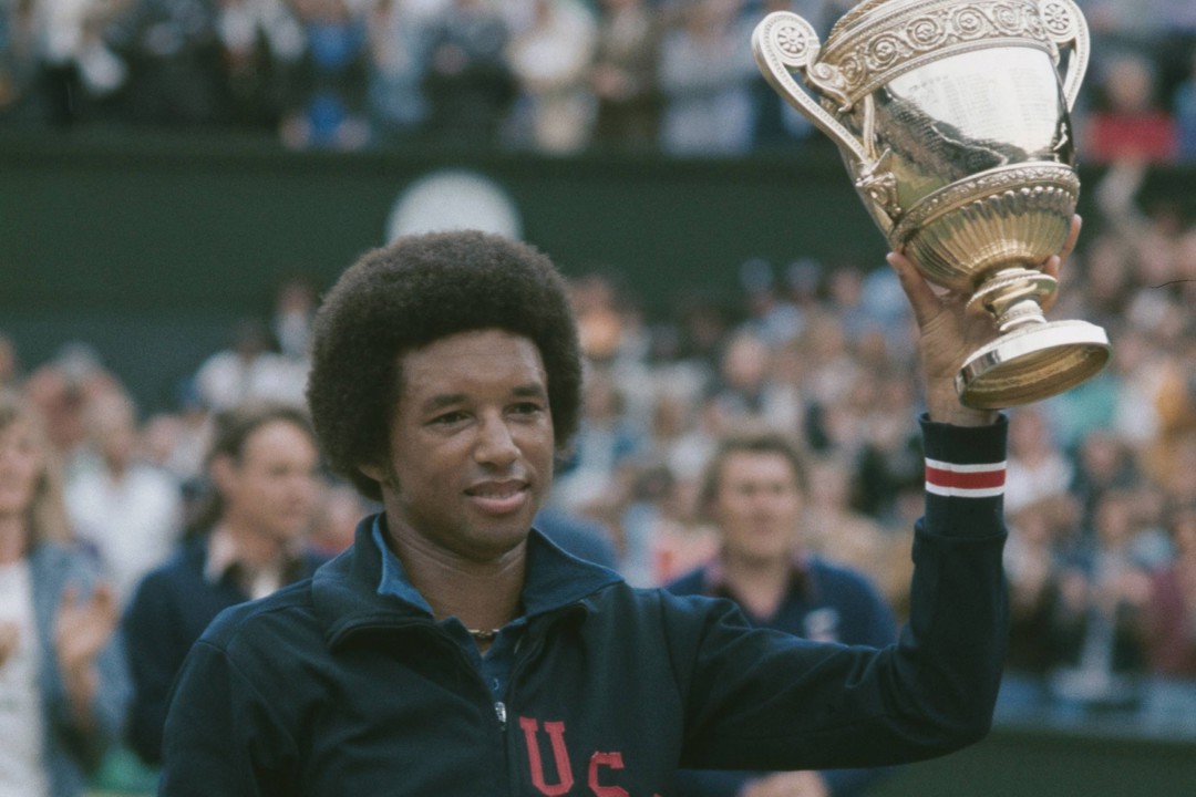 Arthur Ashe holding the Wimbledon men's singles trophy
