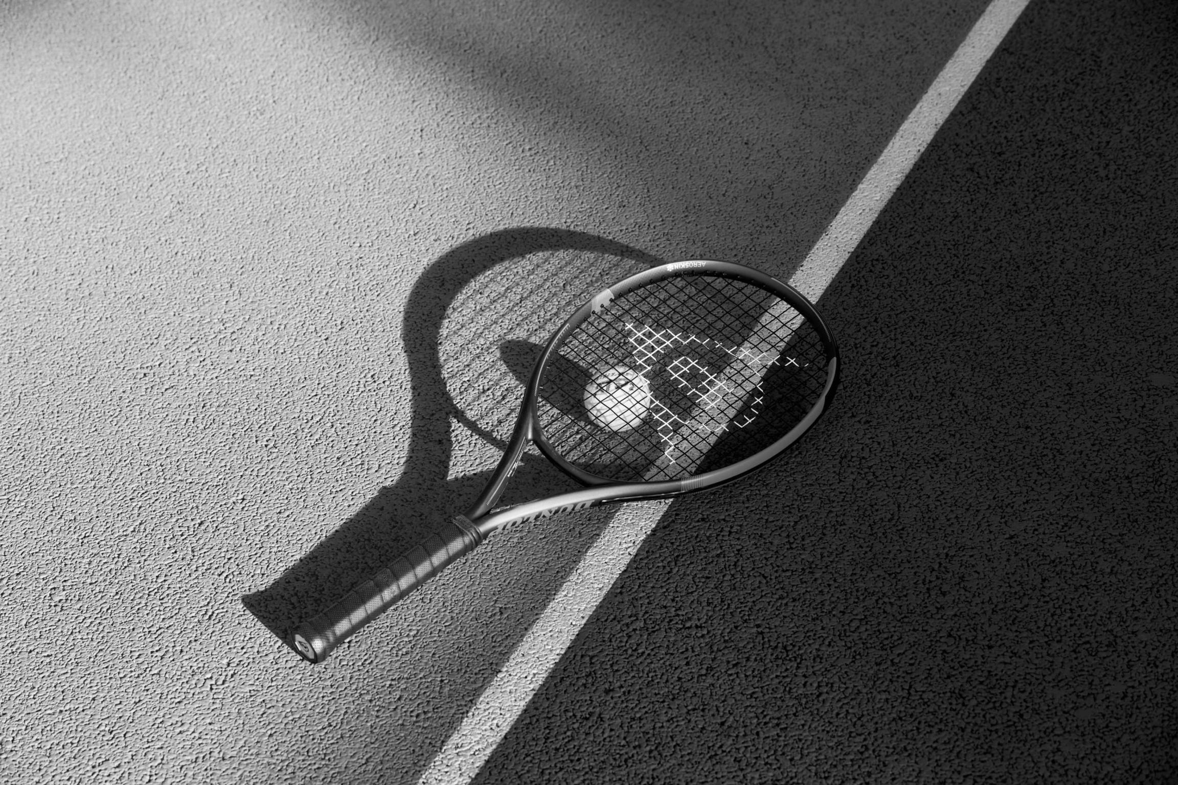 Tennis racket lying on a court