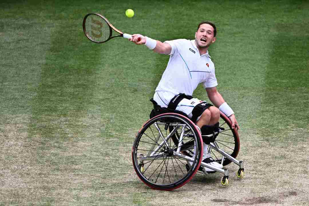 Alfie Hewett sitting in his wheelchair about to hit a forehand on court at the Wimbledon final
