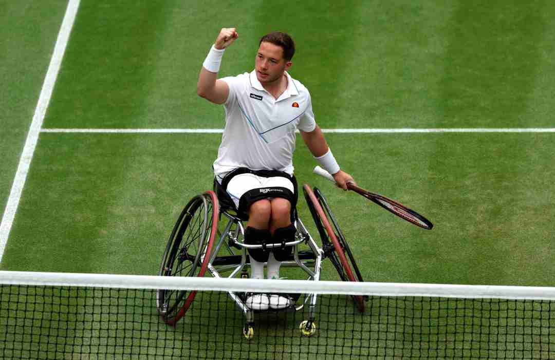 Alfie Hewett sat in his wheelchair on court, raising his fist in celebration