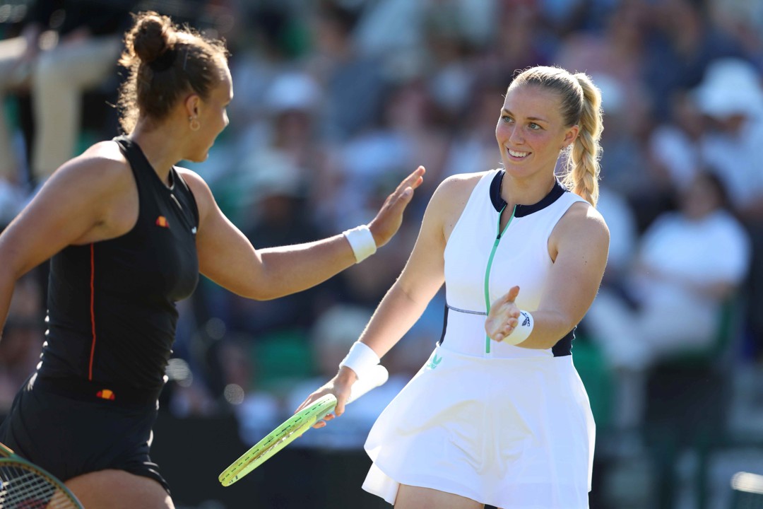Ali Collins high-fiving doubles partner Freya Christie on court 