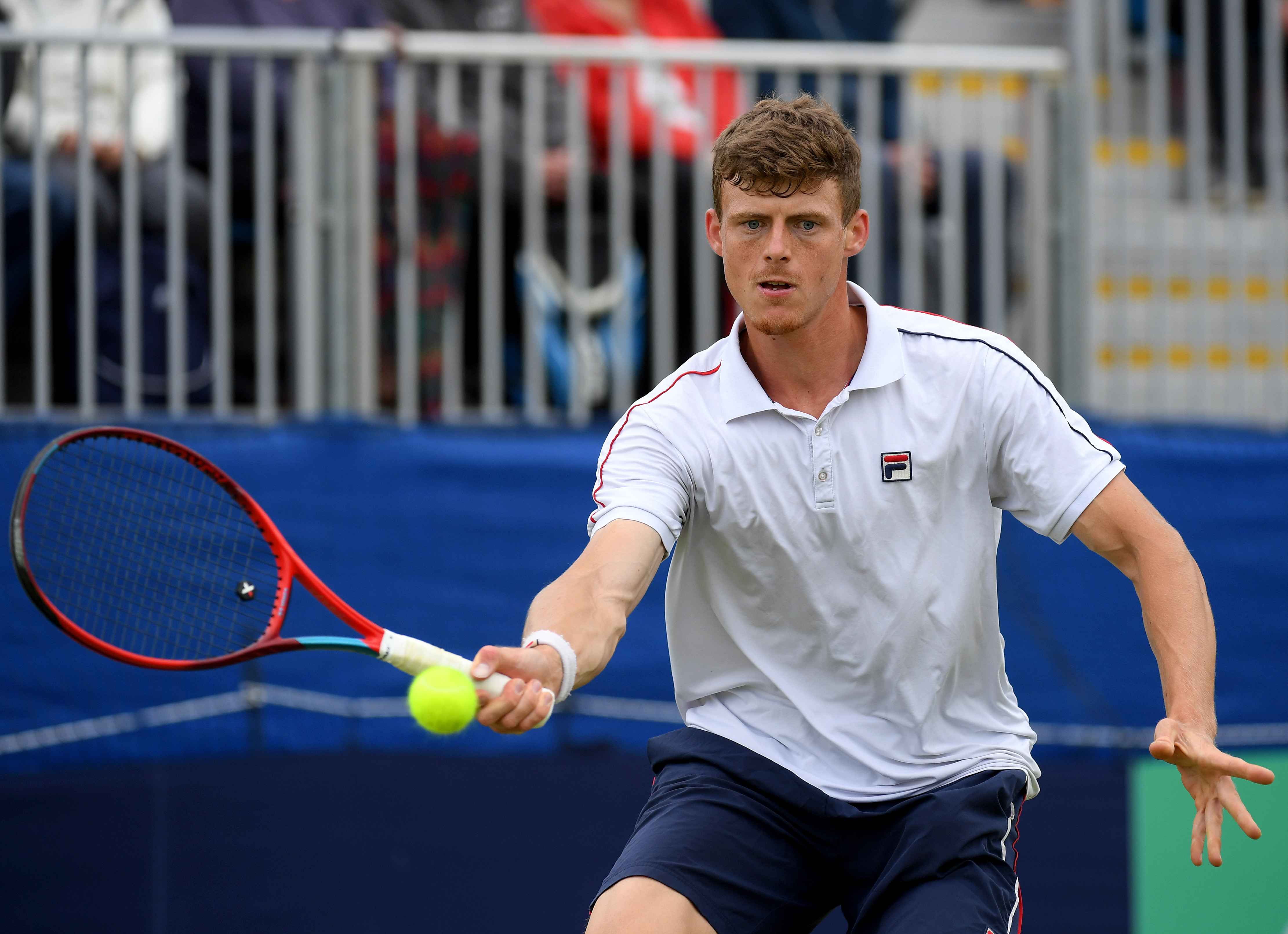 Billy Harris hitting a forehand on court at the Wimbledon qualifiers