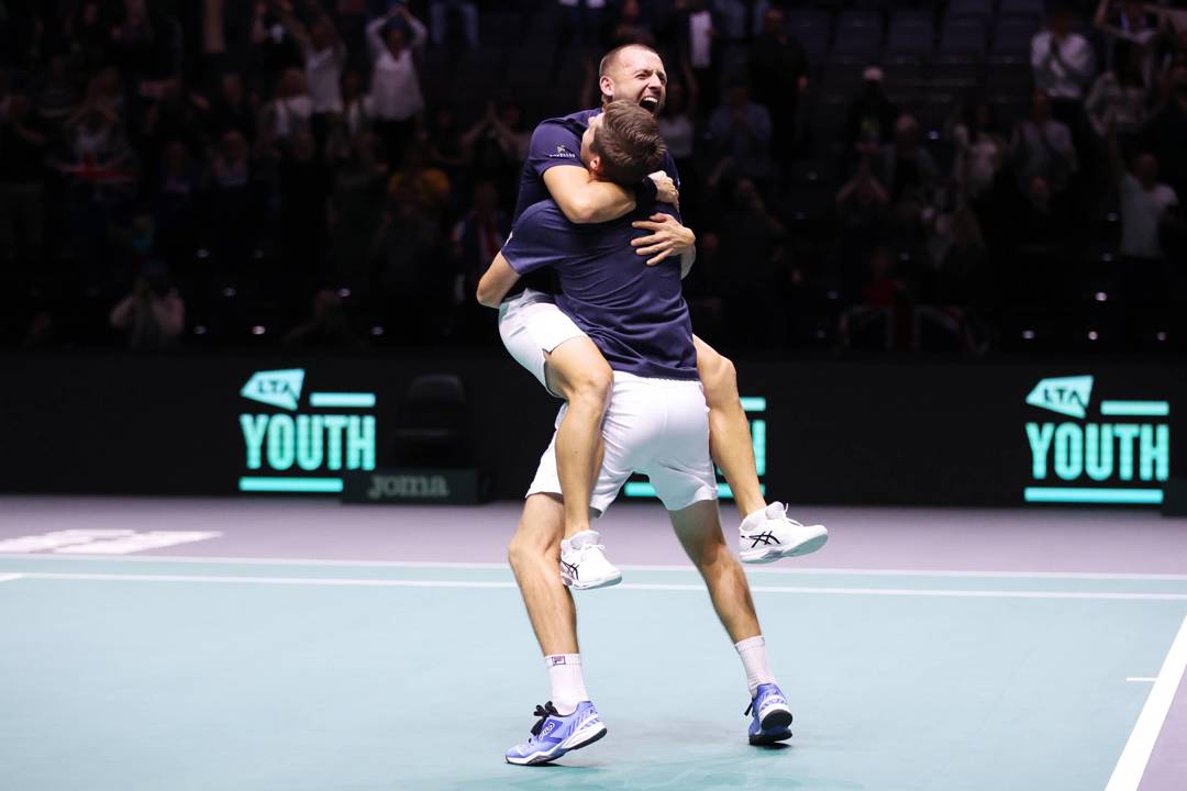 Dan Evans and Neal Skupski hug after clinching the doubles decider at the Davis Cup against France