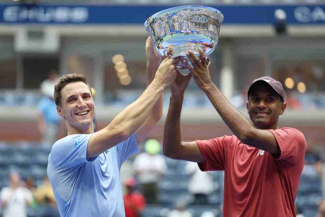 Joe Salisbury and Rajeev Ram lifting their championship trophy on court at the US Open