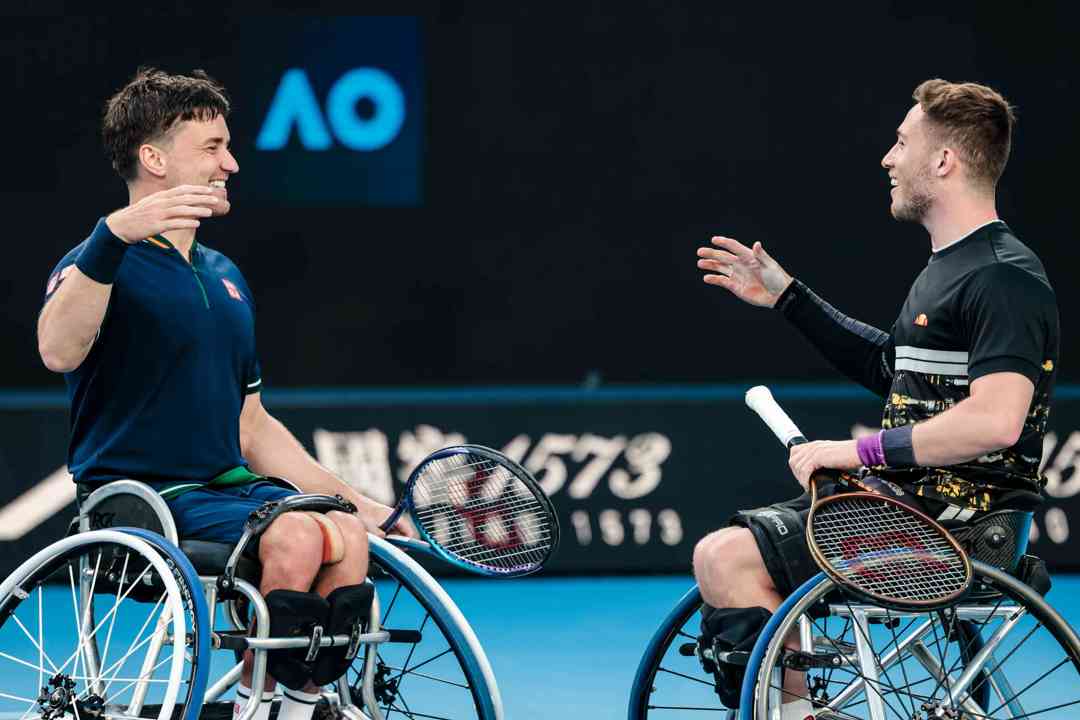 Alfie Hewett and Gordon Reid shaking hands on court after lifting their 5th successive Aus Open wheelchair doubles title