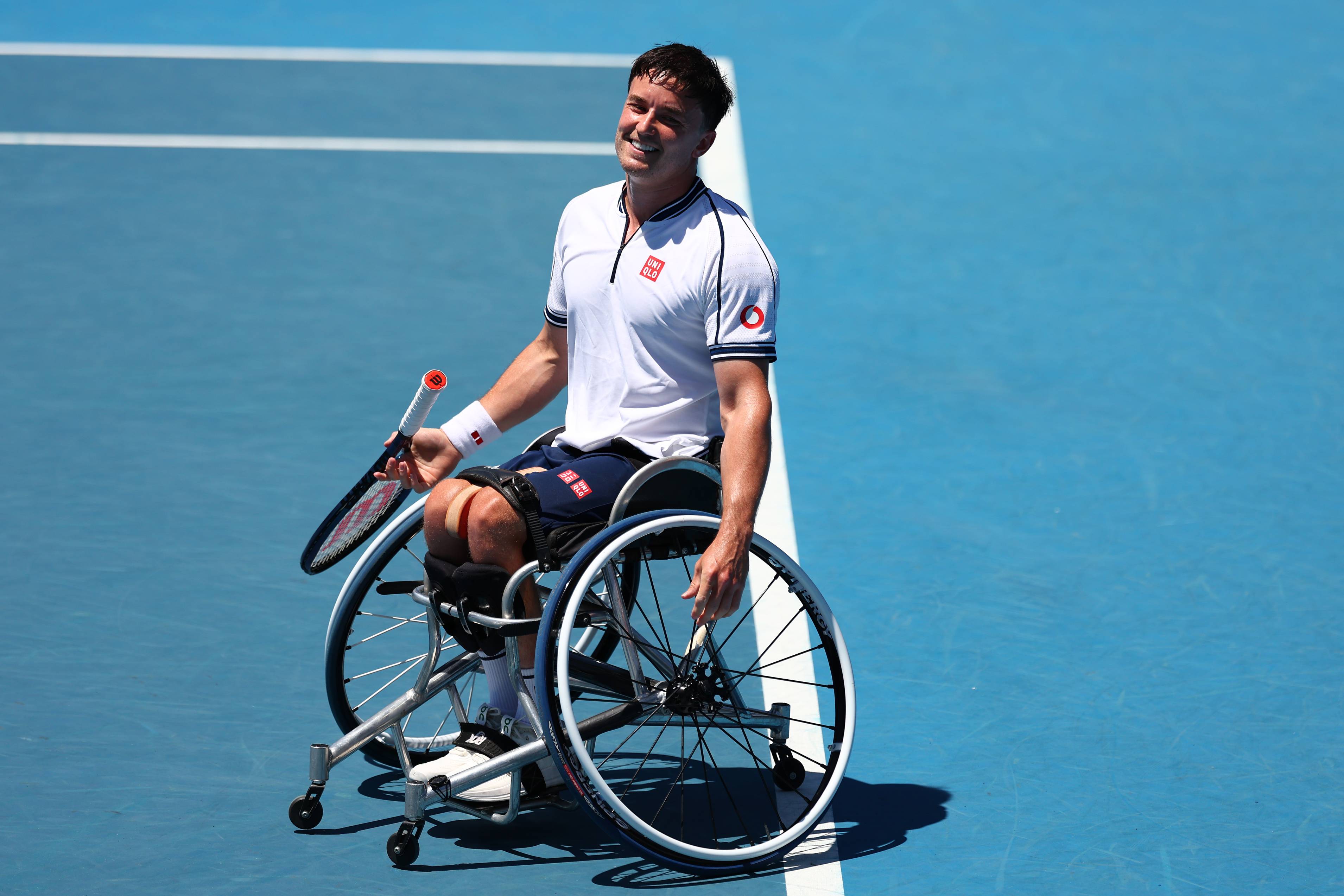 Gordon Reid sat in his wheelchair on court while smiling at the Australian Open
